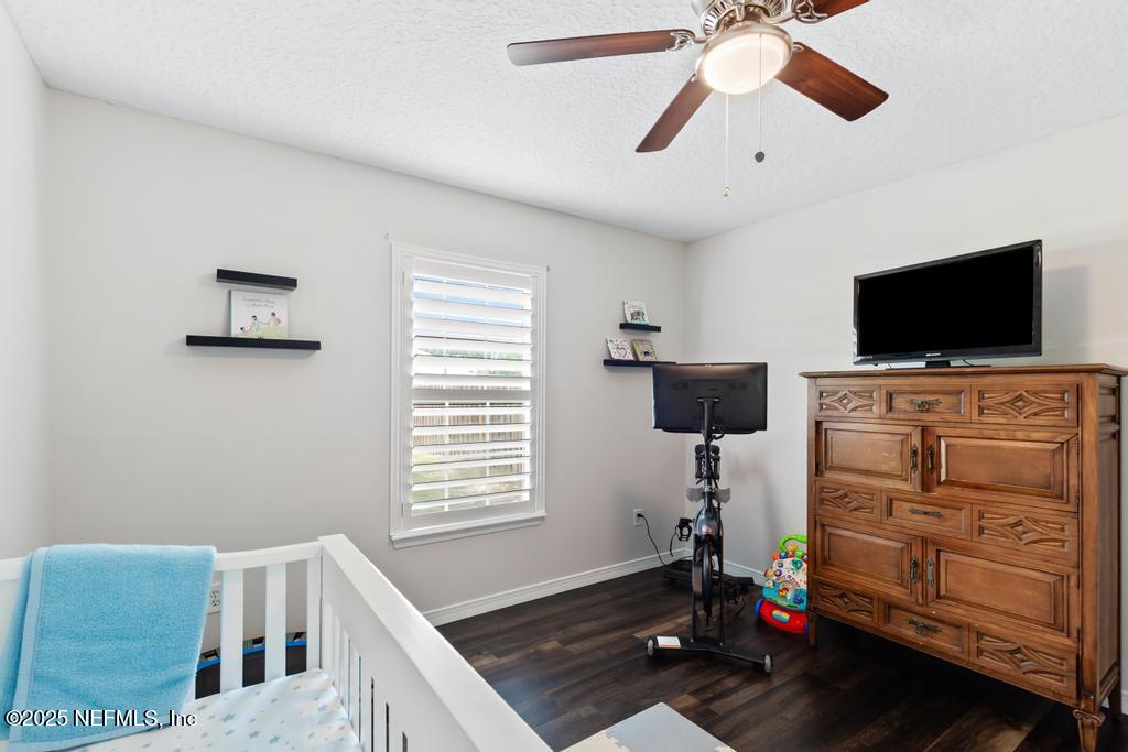 44677 Green Meadows Lane Callahan, FL 32011 - Photo 24 of 91 a bedroom with furniture and a flat screen tv