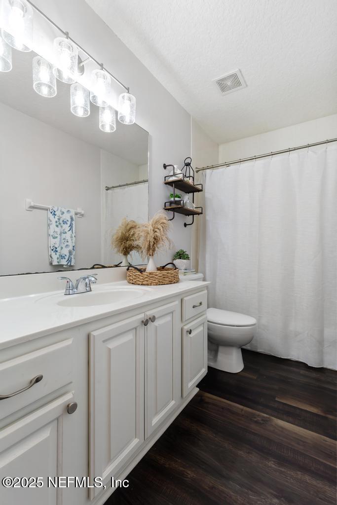 44677 Green Meadows Lane Callahan, FL 32011 - Photo 27 of 91 a bathroom with a granite countertop sink a toilet and mirror
