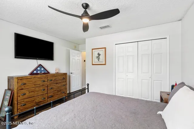 an empty room with wooden floor and closet