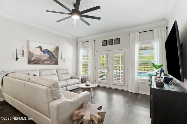 a bedroom with a bed and a flat tv screen on dresser