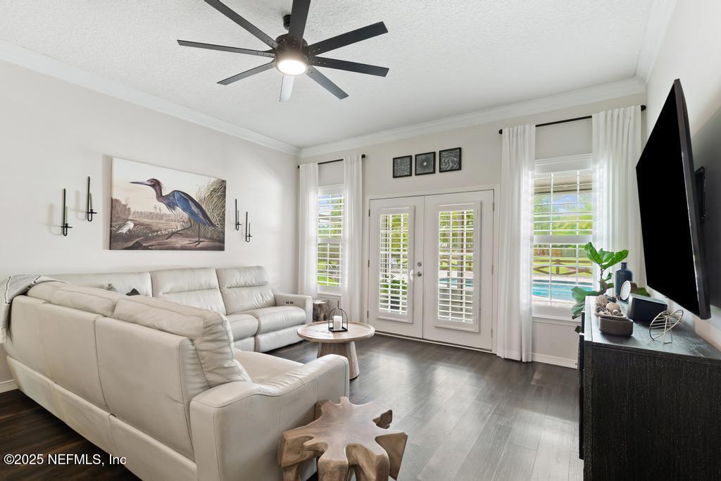 44677 Green Meadows Lane Callahan, FL 32011 - Photo 31 of 91 a living room with furniture a flat screen tv and a large window