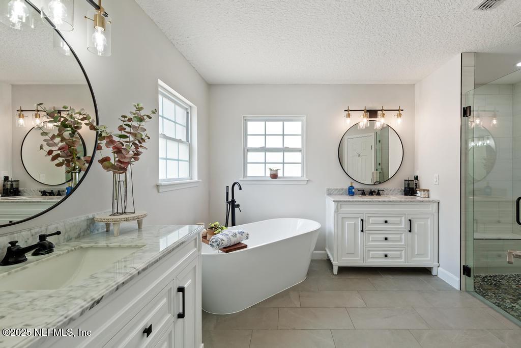 44677 Green Meadows Lane Callahan, FL 32011 - Photo 45 of 91 a bathroom with a granite countertop sink mirror vanity and bathtub