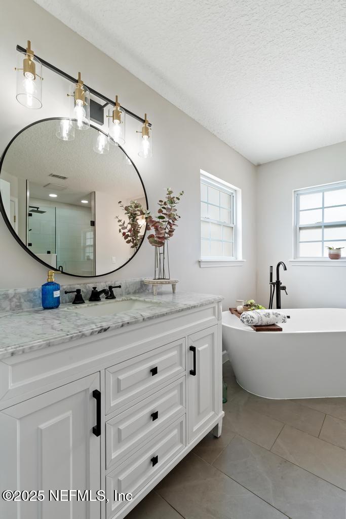 44677 Green Meadows Lane Callahan, FL 32011 - Photo 47 of 91 a spacious bathroom with a granite countertop sink a mirror and bathtub