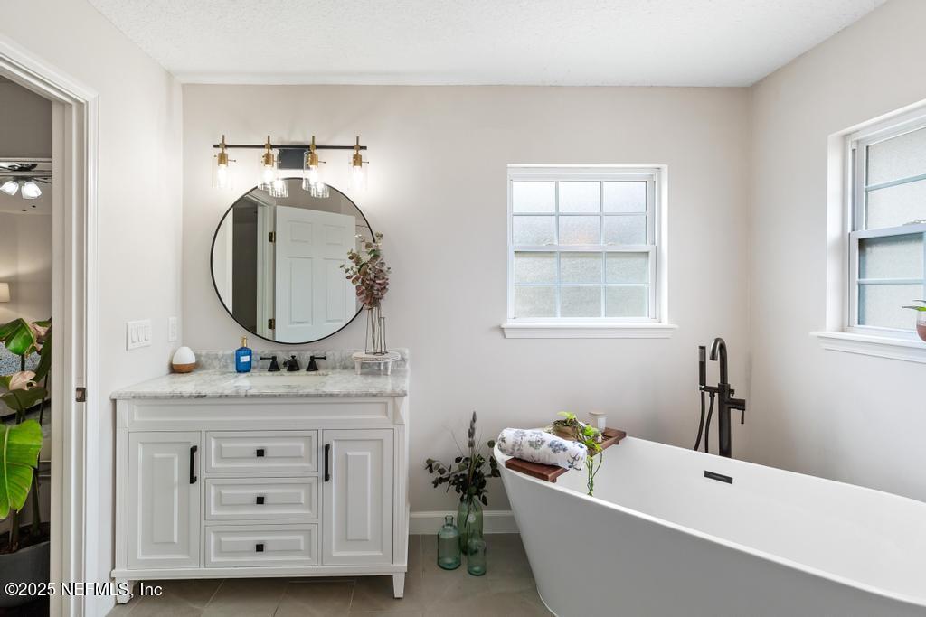 44677 Green Meadows Lane Callahan, FL 32011 - Photo 51 of 91 a bathroom with a tub sink and mirror
