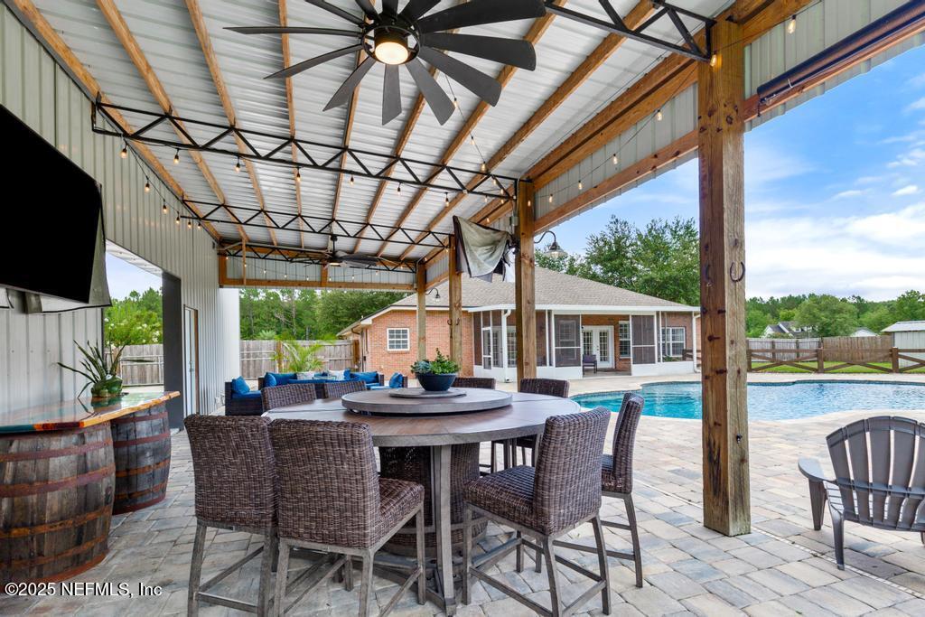 44677 Green Meadows Lane Callahan, FL 32011 - Photo 66 of 91 a view of a patio with a table and chairs