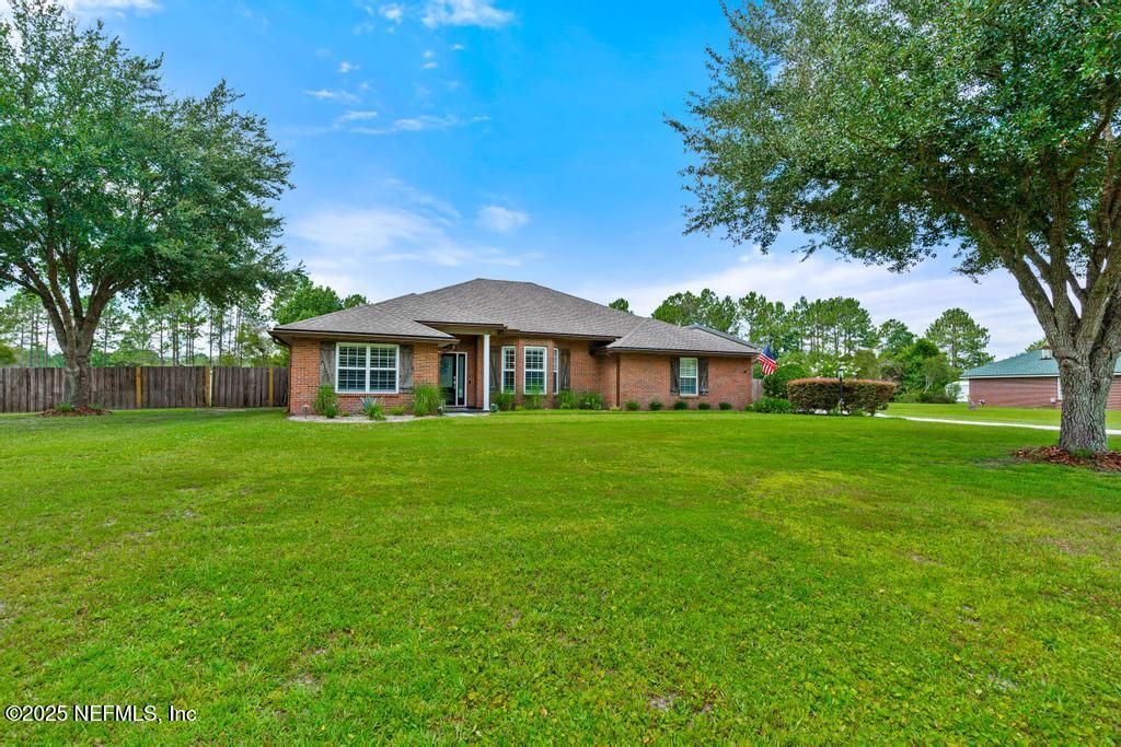 44677 Green Meadows Lane Callahan, FL 32011 - Photo 8 of 91 a front view of house with yard and green space