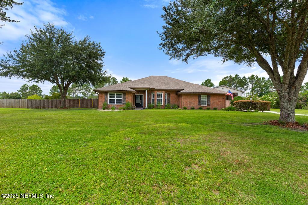 44677 Green Meadows Lane Callahan, FL 32011 - Photo 9 of 91 a front view of house with yard and green space
