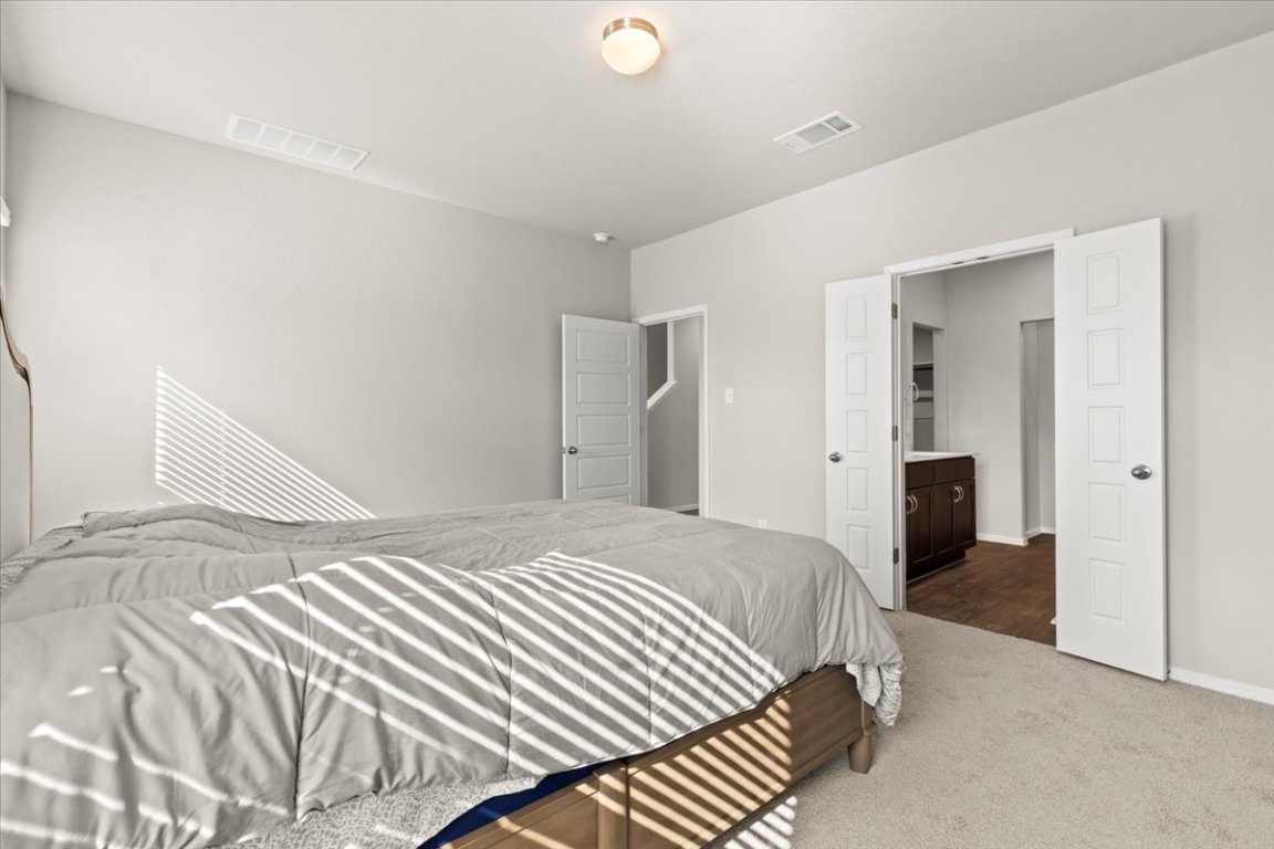 1296 Teychas Drive Kyle, TX 78640 - Photo 15 of 39 a bedroom with a bed and closet