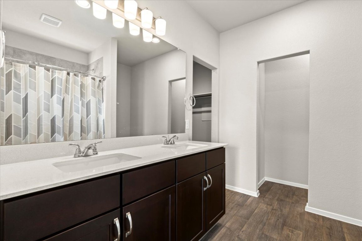 1296 Teychas Drive Kyle, TX 78640 - Photo 16 of 39 a bathroom with a sink double vanity and a mirror