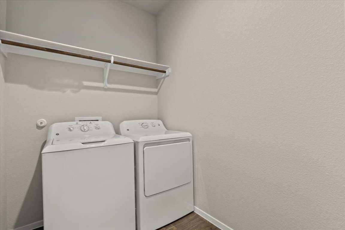 1296 Teychas Drive Kyle, TX 78640 - Photo 28 of 39 Laundry room featuring washer and dryer, baseboards, and dark wood-type flooring