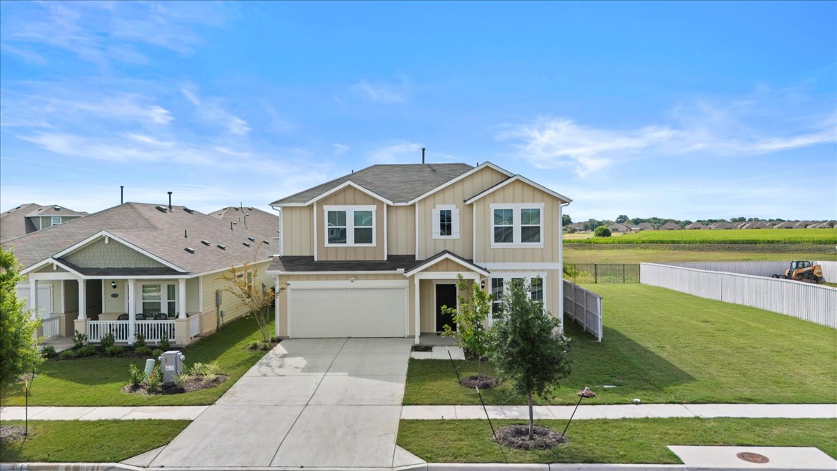 1296 Teychas Drive Kyle, TX 78640 - Photo 37 of 39 a front view of a house with a yard