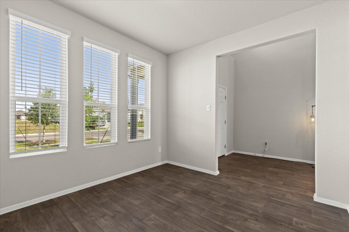 1296 Teychas Drive Kyle, TX 78640 - Photo 6 of 39 a view of an empty room with wooden floor and a window