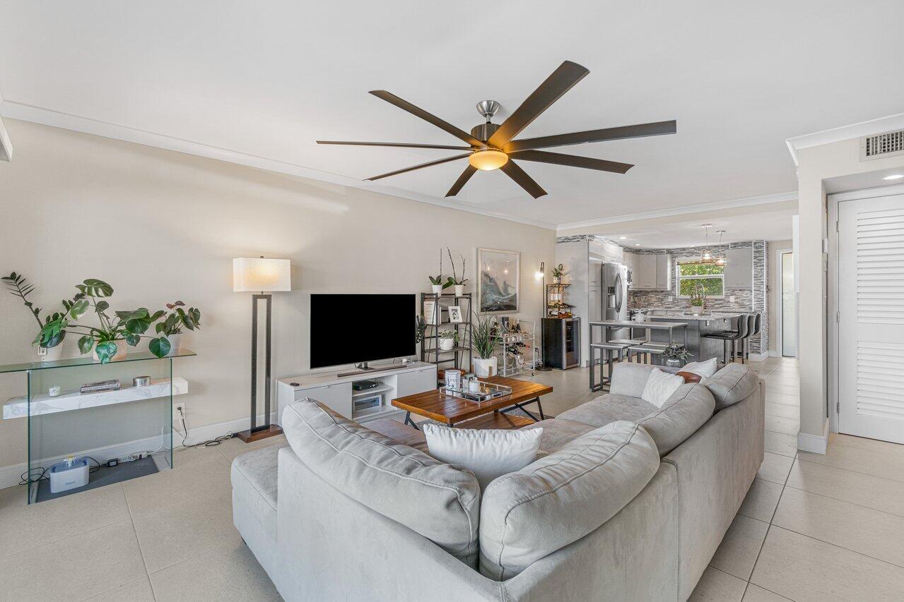 2311 Northeast 36th Street, Unit 1A Lighthouse Point, FL 33064 - Photo 11 of 29 a living room with furniture and a flat screen tv