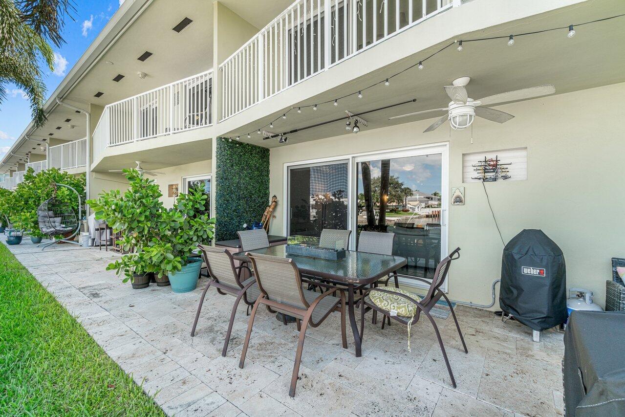 2311 Northeast 36th Street, Unit 1A Lighthouse Point, FL 33064 - Photo 22 of 29 a view of an chairs and tables in the patio