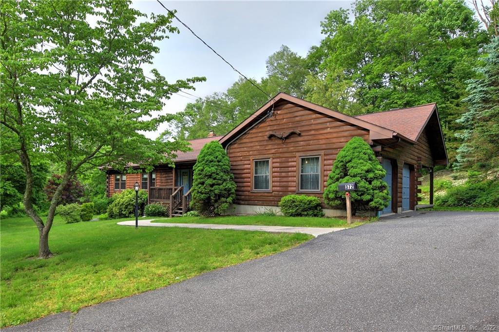 372 Quaker Farms Road Oxford, CT 06478 - Photo 1 of 1 a front view of a house with a yard and trees