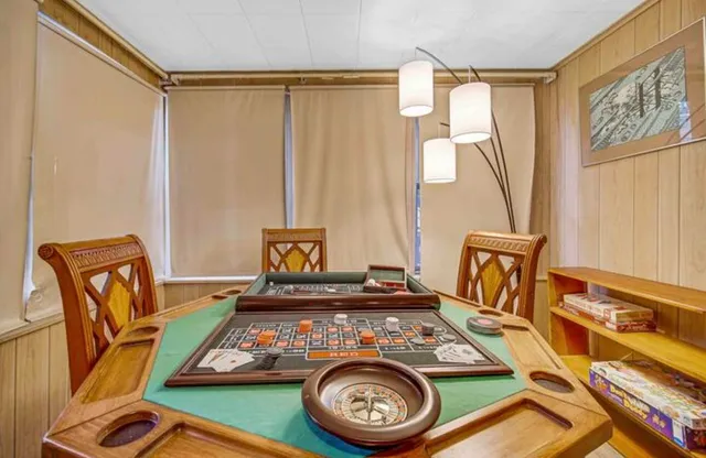 a bedroom with a bed next to a window