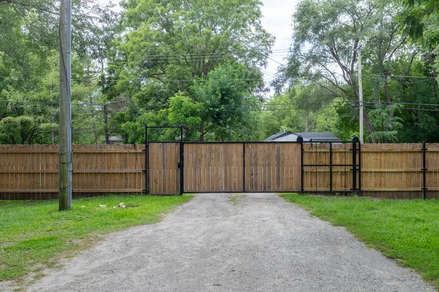 a view of a backyard with wooden fence