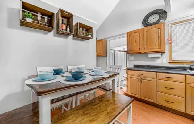 a kitchen with stainless steel appliances granite countertop a stove a sink and a microwave