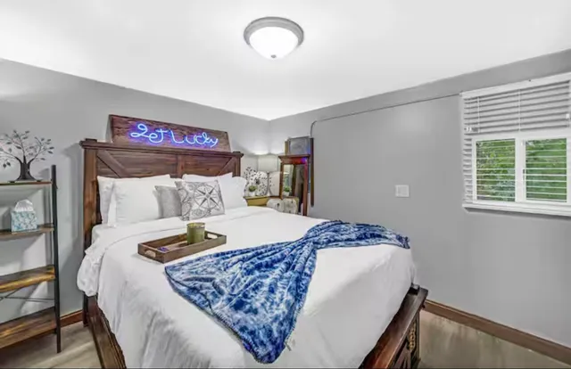 a bed sitting in a bedroom next to a window