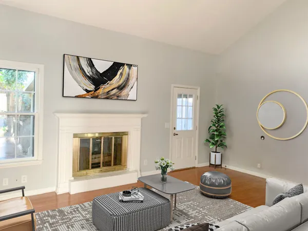 a living room with furniture and a potted plant