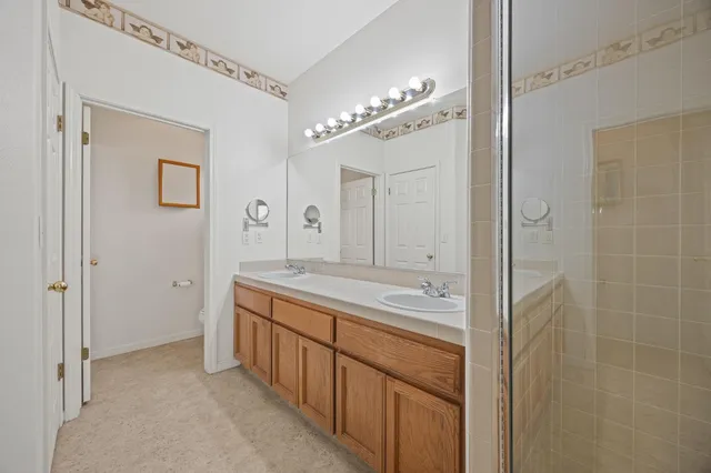 a bathroom with a double vanity sink and mirror