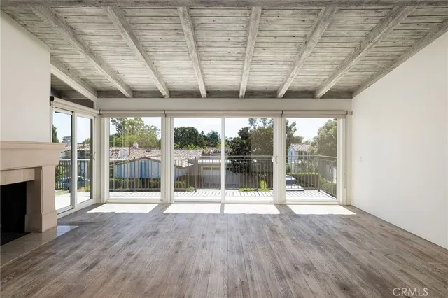 a room with wooden floor and fireplace