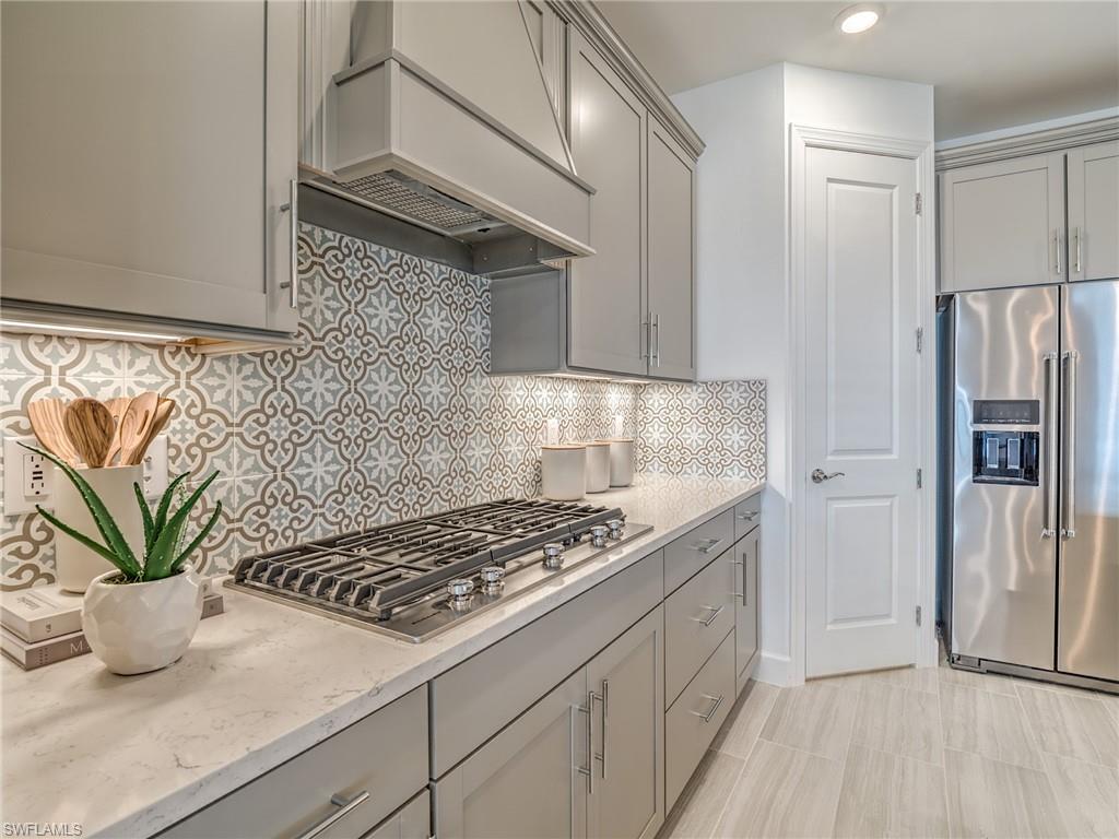 15635 Northridge Road Punta Gorda, FL 33982 - Photo 11 of 49 a kitchen with stainless steel appliances granite countertop a refrigerator a sink a stove and cabinets