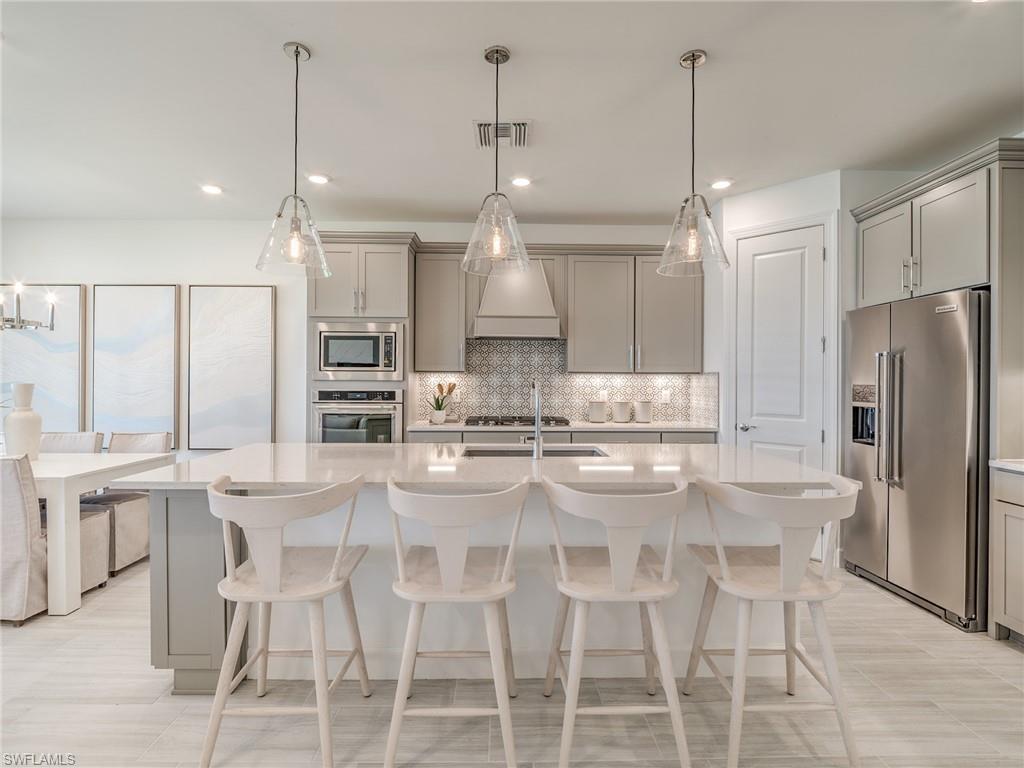 15635 Northridge Road Punta Gorda, FL 33982 - Photo 8 of 49 a kitchen with kitchen island granite countertop a center island and stainless steel appliances