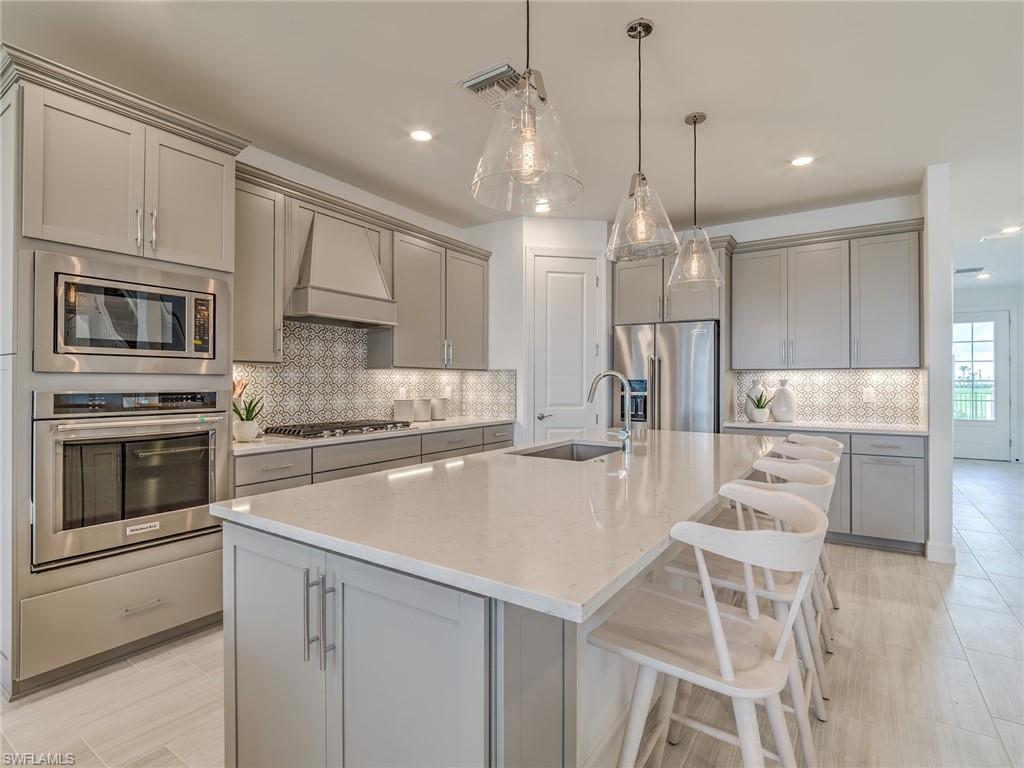 15635 Northridge Road Punta Gorda, FL 33982 - Photo 10 of 49 a kitchen with white cabinets and stainless steel appliances