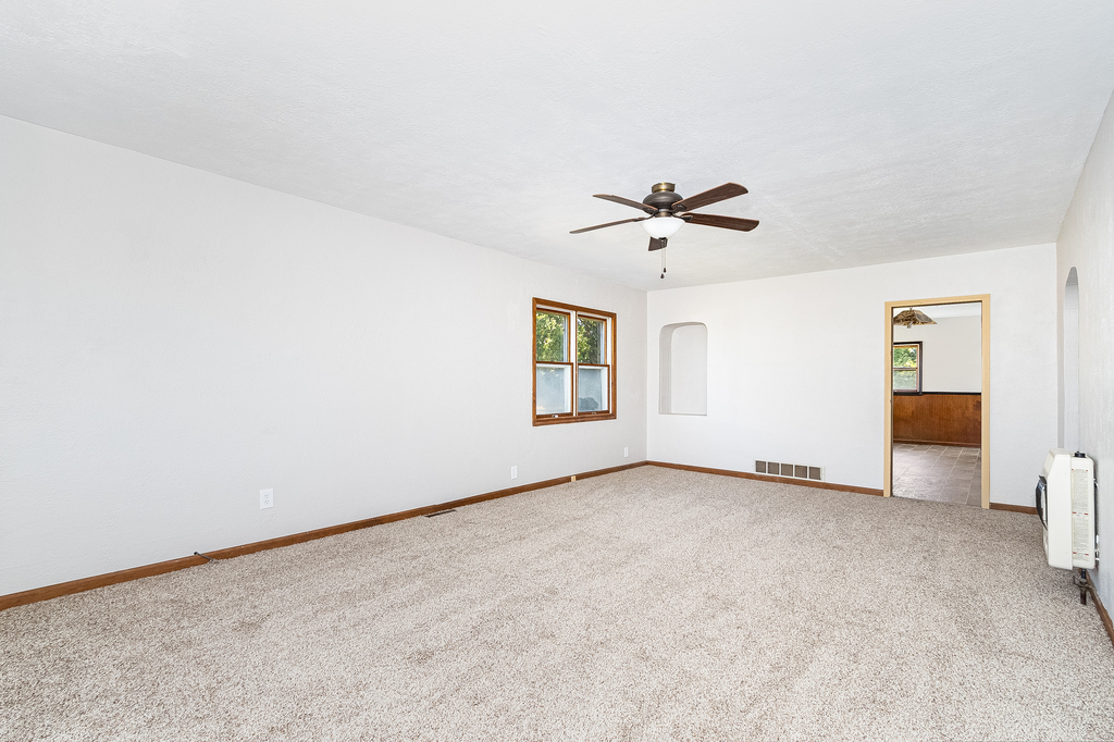 25265 South Chicago Road Elwood, IL 60421 - Photo 4 of 16 an empty room with chandelier fan and windows
