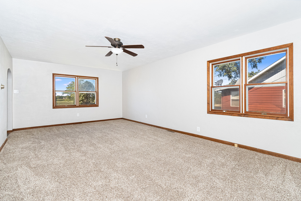25265 South Chicago Road Elwood, IL 60421 - Photo 5 of 16 an empty room with windows and ceiling fan