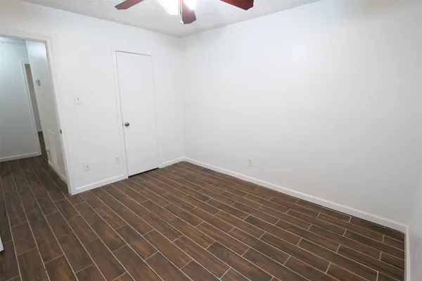 a view of a room with wooden floor and white walls