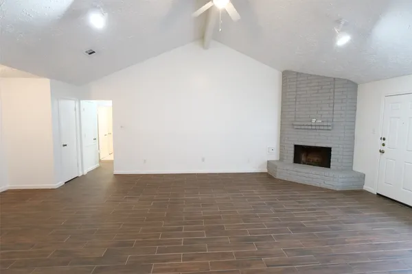 a view of an empty room with a fireplace
