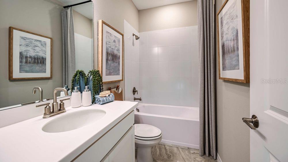 6917 Prairie Oak Way Nokomis, FL 34275 - Photo 11 of 28 a bathroom with a sink toilet and shower