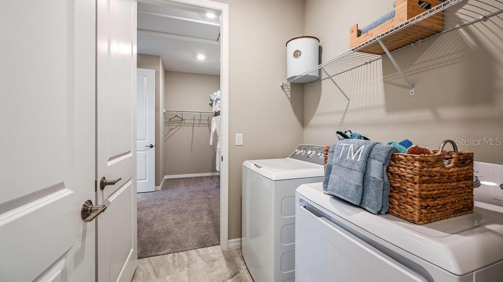 6917 Prairie Oak Way Nokomis, FL 34275 - Photo 13 of 28 a utility room with dryer and washer