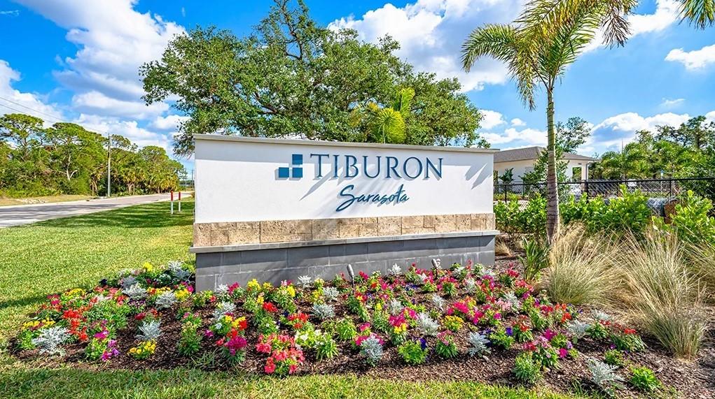 6917 Prairie Oak Way Nokomis, FL 34275 - Photo 15 of 28 a sign that is in front of flowers