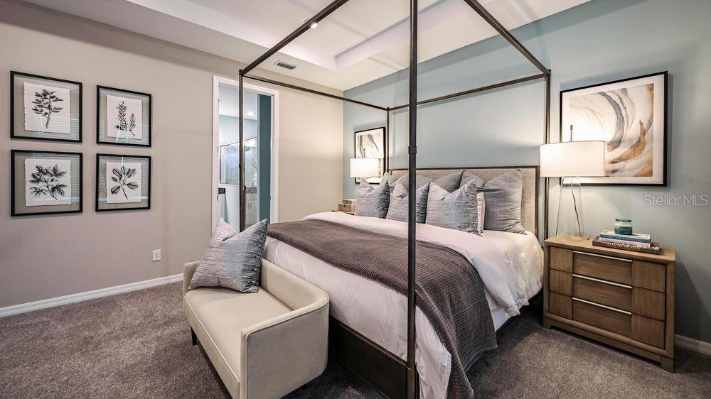 6917 Prairie Oak Way Nokomis, FL 34275 - Photo 8 of 28 a bedroom with a bed and wooden floor