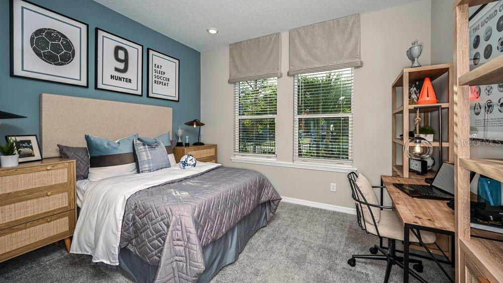 6917 Prairie Oak Way Nokomis, FL 34275 - Photo 10 of 28 a bedroom with a bed and a table in it