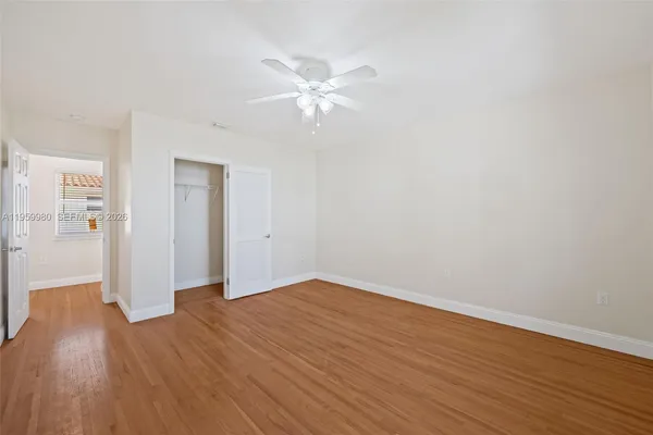 a view of empty room with wooden floor
