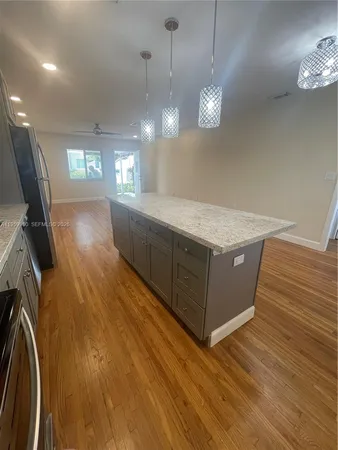 a room with hard wood floors and a ceiling fan