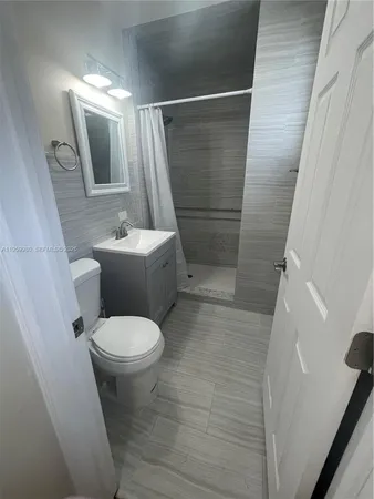 a toilet sitting in a bathroom next to a sink