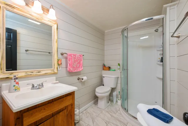 a bathroom with a sink toilet and shower