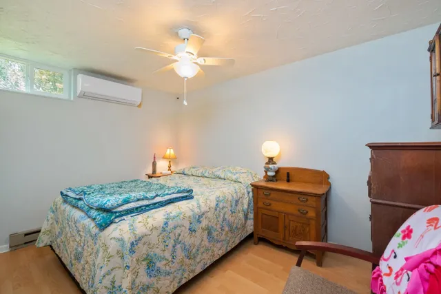 a bedroom with a bed and a chandelier