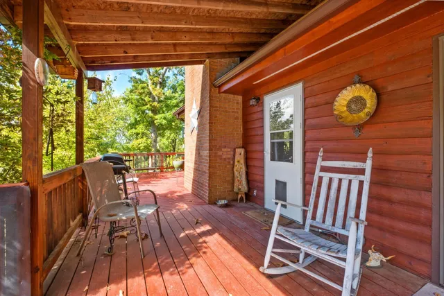 a view of deck with two chairs and wooden floor