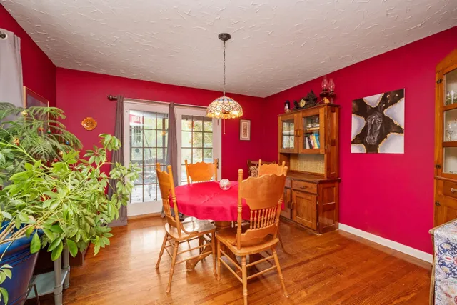 a dining room with furniture and window