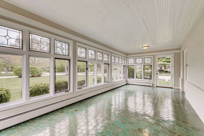 321 North Delaplaine Road Riverside, IL 60546 - Photo 13 of 52 a view of an empty room with wooden floor and a window