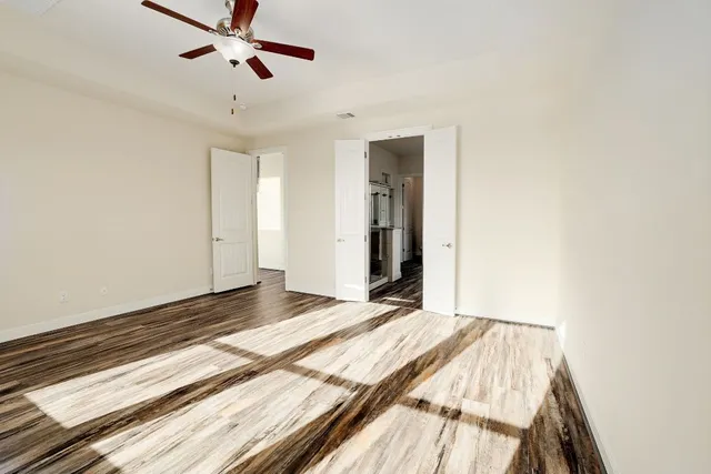 a view of a room with a ceiling fan
