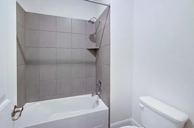 a bathroom with a bathtub and a toilet