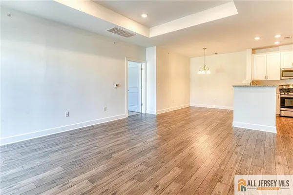 a view of a kitchen with wooden floor
