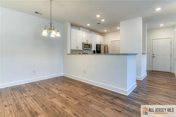 a view of a kitchen with a sink and wooden floor